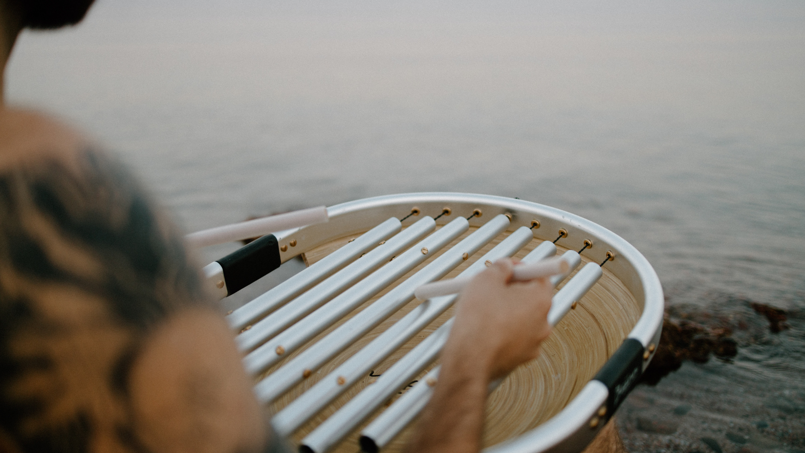 bajinn played next to water with tatto on right hand